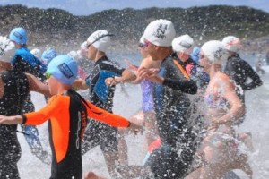 Swimmers running into water for Rock 2 Ramp Swim